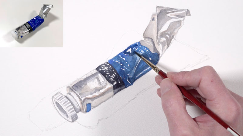 Adding darker values to the watercolor painting of a paint tube