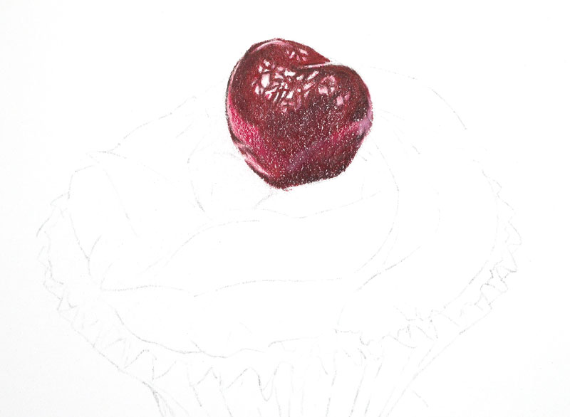 Colored pencil applications on the cherry on top of the cupcake