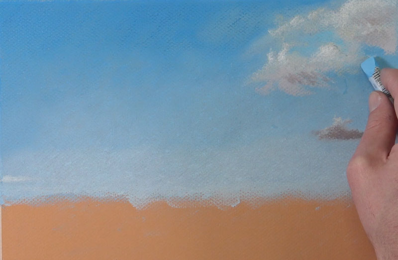 Painting clouds in a pastel landscape