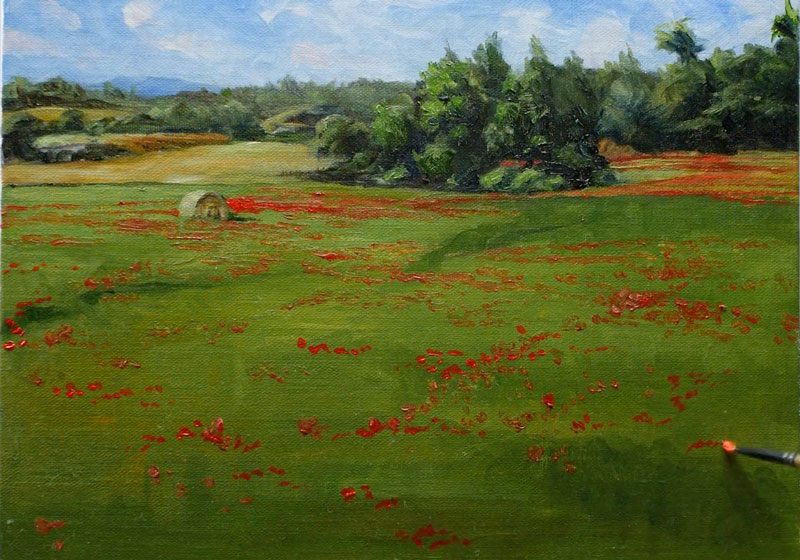 Painting the red flowers and hay bale in the landscape